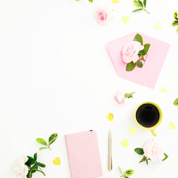 istock Love composition with roses, paper envelope, notebook and mug of cappuccino white background. Flat lay, top view 1164304592