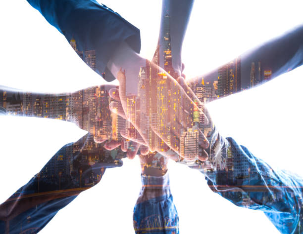 istock Double exposure ofTeamwork Concept,Group of diversity people to greeting power tag team,Teamwork Join Hands Partnership Concept of people putting their hands together,Friends with hands showing unity. 1164305311