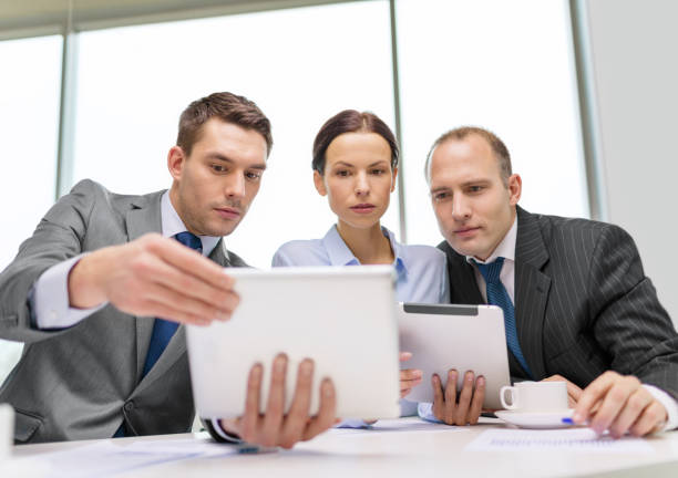 istock business team with tablet pc having discussion 1164306925
