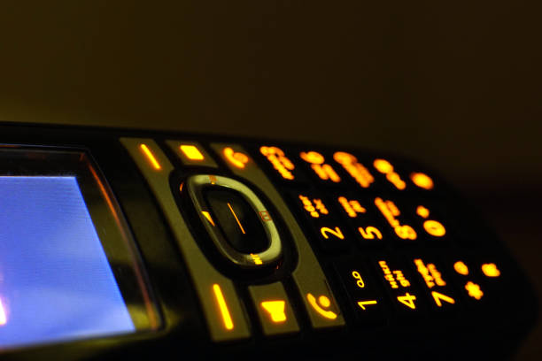 istock Glowing phone buttons in the dark macro shot, selective focusing 1164307864
