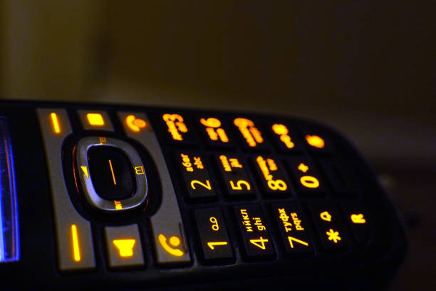 istock Glowing phone buttons in the dark macro shot, selective focusing 1164308170