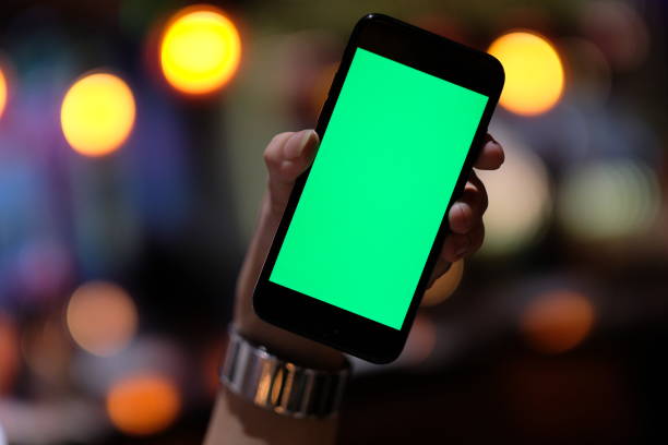 istock close up one hand holding a green screen smartphone 1164312420