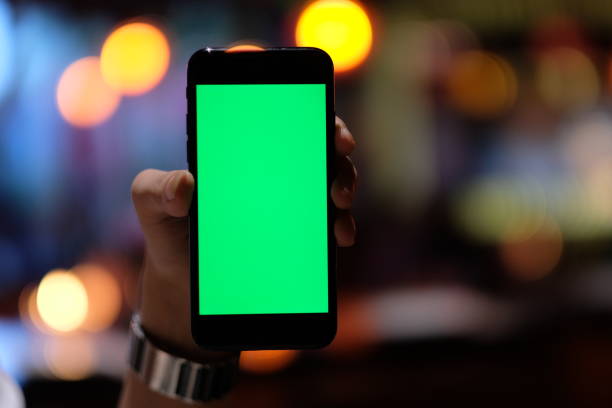 istock close up one hand holding a green screen smartphone 1164312474