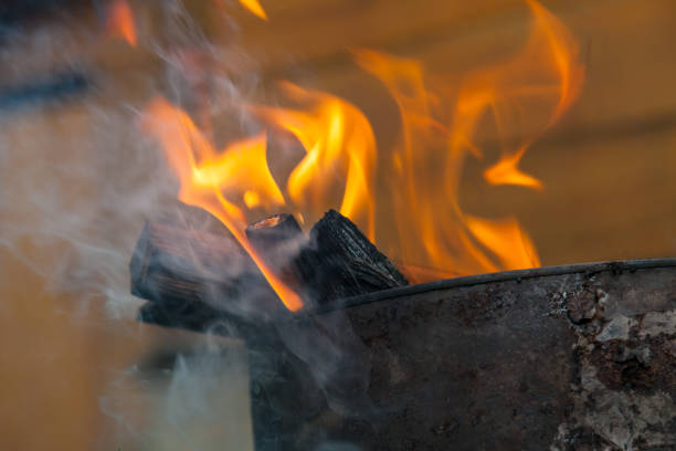 istock Close-up on a fire during a fire or burning fire on the background of a wooden wall. Work for firefighters. 1164313539