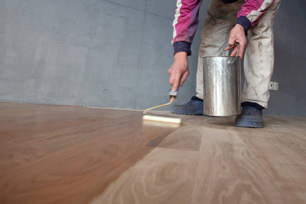 Worker Varnishing Lacquering a Parquet stock photo