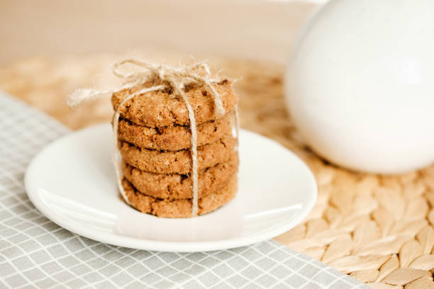 istock A stack of oatmeal cookies tied with a rope on a light background. Daylight 1164314218