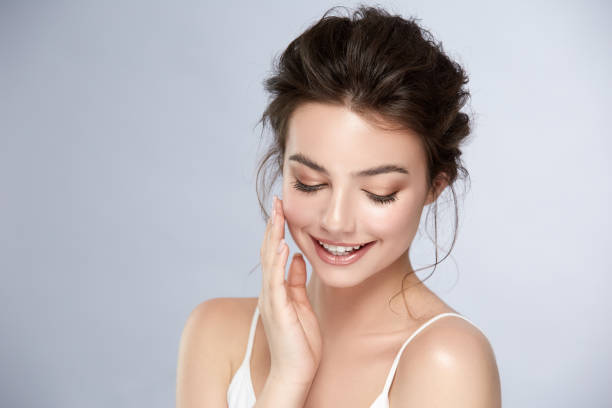 istock cute girl with natural make-up smiling and looking down 1164316536