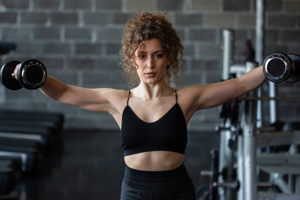 istock Handsome girl workout in gym 1164316628