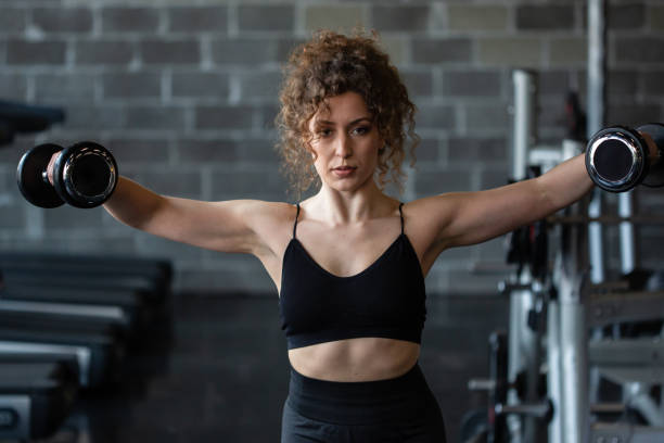 istock Handsome girl workout in gym 1164316631