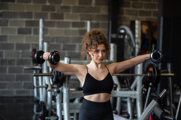 istock Handsome girl workout in gym 1164316633