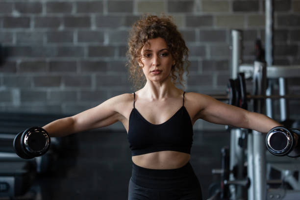 istock Handsome girl workout in gym 1164316634