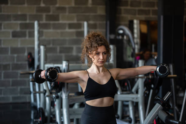 istock Handsome girl workout in gym 1164316671