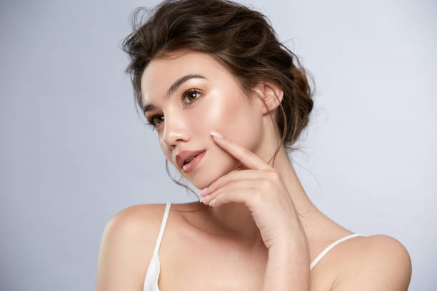 istock sexy lady with shiny highlighter looking to the side and touching face 1164316887