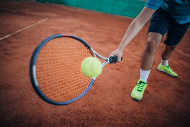istock Tennis player hitting a ball with a racket 1164318633