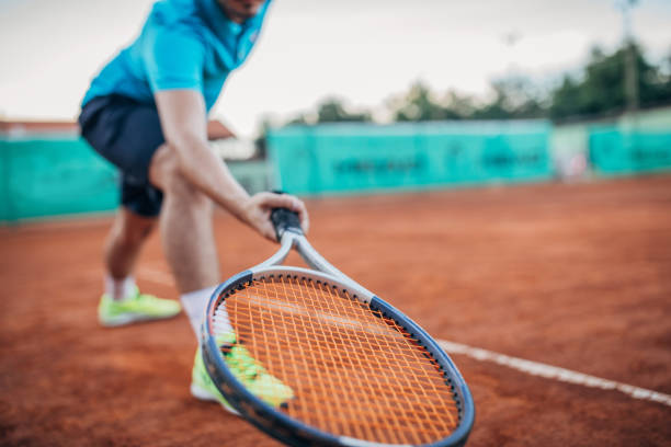 istock Tennis player with a racket on clay court 1164318717
