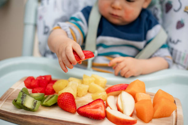 istock Baby Enjoying Fruit Salad 1164318981