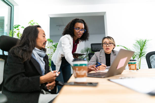 istock Brainstorming in the boardroom between multi-ethnic coworkers 1164319016