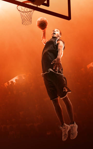 istock Basketball player making a basket. Jump shot. Slam Dunk 1164323219