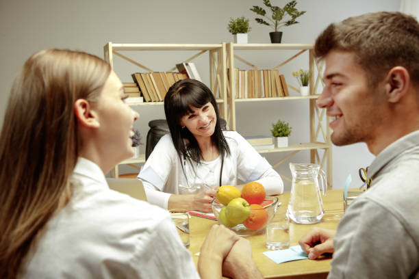 istock Smiling nutritionist showing a healthy diet plan to patient 1164323483