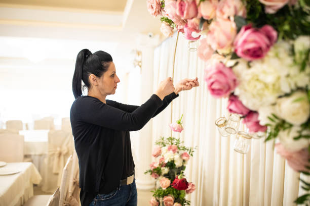 istock Designer working on wedding decoration in restaurant 1164323985