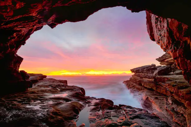 Photo of Coastal cave views to glorious sunrise over the ocean