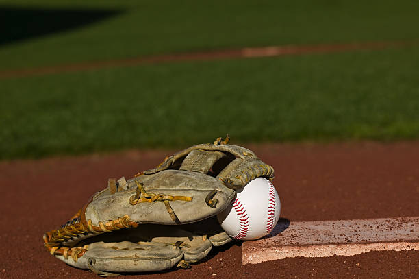 Baseball in glove on the field stock photo