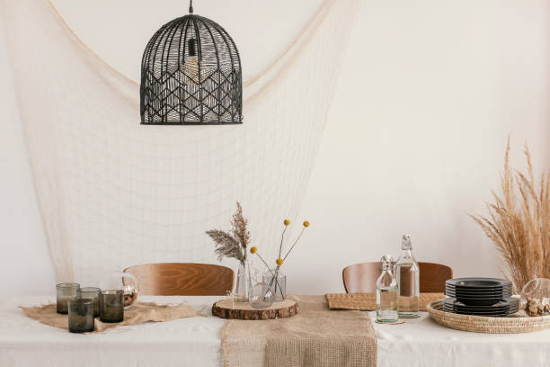 istock Black modern lamp above the table in living room 1164336041