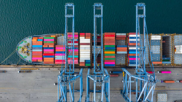 istock Aerial view cargo ship terminal, Unloading crane of cargo ship terminal, Aerial view industrial port with containers and container ship. 1164337977