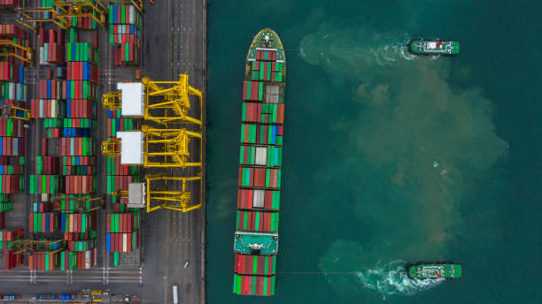 istock Aerial view cargo ship terminal, Unloading crane of cargo ship terminal, Aerial view industrial port with containers and container ship. 1164338076