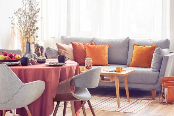 istock Stylish grey chairs at dining table covered with long tablecloth 1164338310