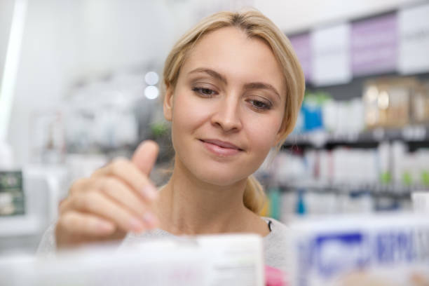istock Charming young woman shopping at pharmacy 1164339204