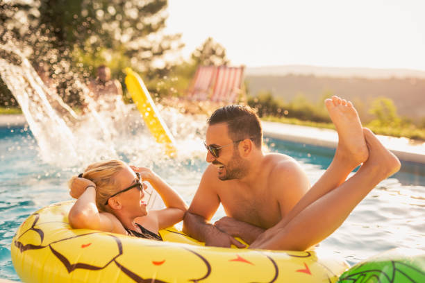 istock Couple having fun at the swimming pool 1164339458