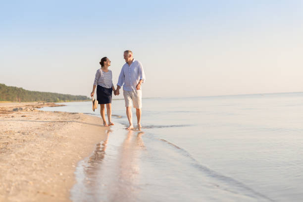 Happy senior couple at beach Happy senior couple at beach baltic sea people stock pictures, royalty-free photos & images