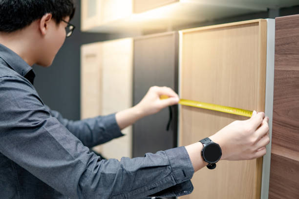 istock Asian man using tape measure on cabinet materials 1164344336