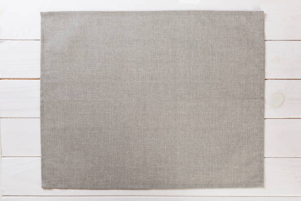 gray cloth napkin on white rustic wooden background top view with copy space gray cloth napkin on white rustic wooden background top view with copy space. linen flax textile burlap stock pictures, royalty-free photos & images