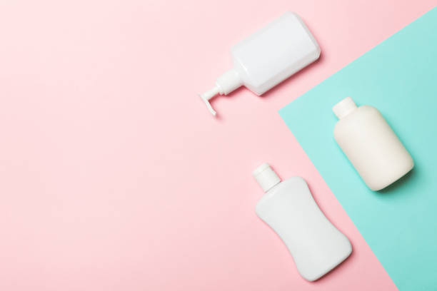 istock Set of White Cosmetic containers isolated on yellow background, top view with copy space. Group of plastic bodycare bottle containers with empty space for you design 1164344422