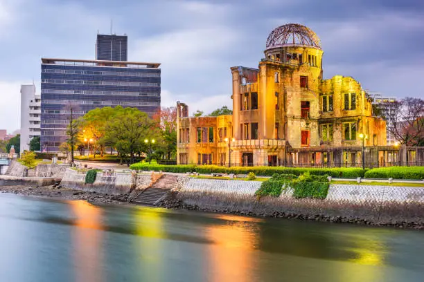 Hiroshima, Japan skyline and Atomic Dome at twilight on the river.