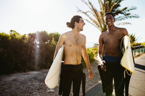 istock Friends going on water surfing 1164344491