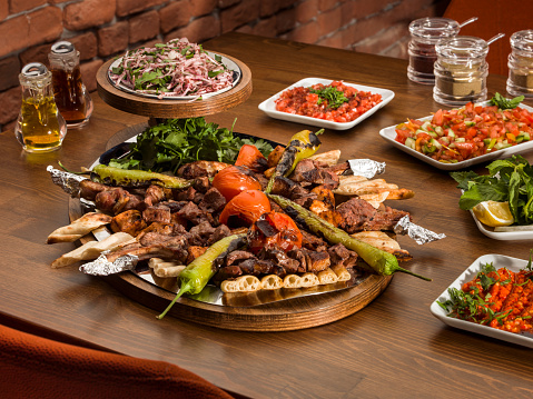Traditional Turkish Kebabson wooden table. Kebabs are various cooked meat dishes, with their origins in Middle Eastern cuisine.