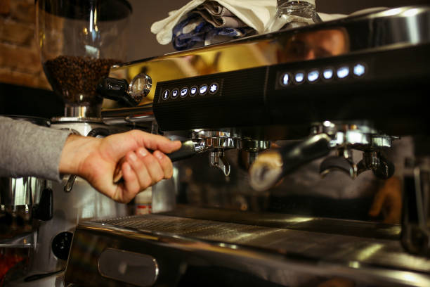 istock Hands of a barista making coffee 1164348684