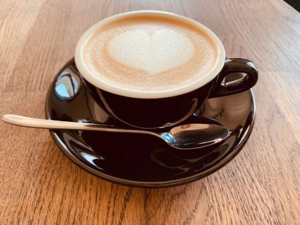 istock Cup of coffee with heart drawn on the table 1164348998