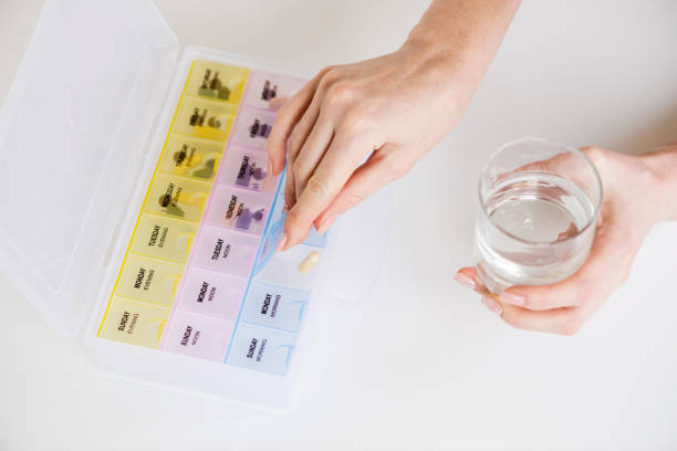 istock Daily pill reminder box on white background. 1164349288