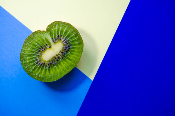istock Half chopped kiwi, on a geometric background 1164350139
