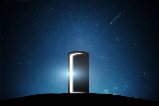 istock Silhouette of Door opened light with night sky 1164350726
