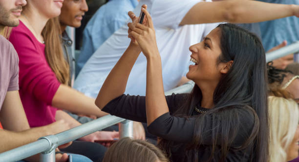 istock Spectator photographing in stadium 1164352050