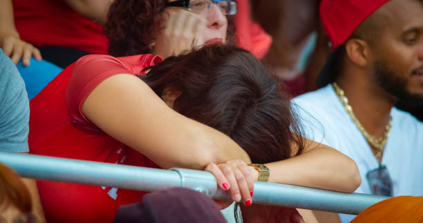 Sad female fan sitting in stadium