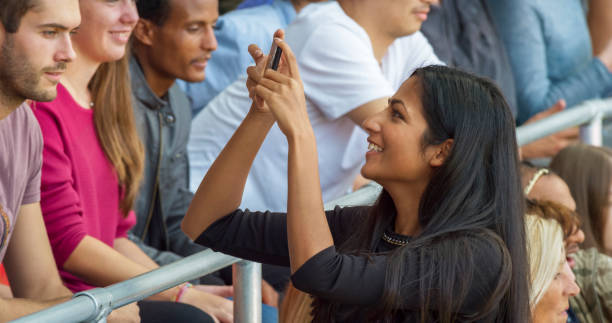 istock Spectator photographing in stadium 1164352137