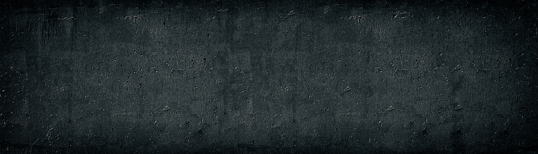 Black old concrete wall wide texture. Rough cement surface long panorama. Dark gray gloomy grunge panoramic background