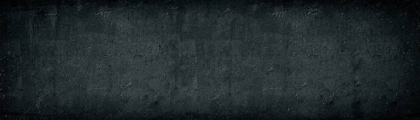 Black old concrete wall wide texture. Rough cement surface long panorama. Dark gray gloomy grunge panoramic background Black old concrete wall wide texture. Rough cement surface long panorama. Dark gray gloomy grunge panoramic background high resolution stock pictures, royalty-free photos & images