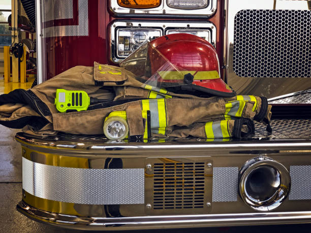 istock Firefighter helmet and gear on the fire truck 1164354064